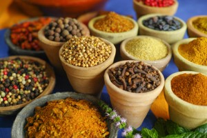 Collection of different spices in old clay bowls in colorful oriental style