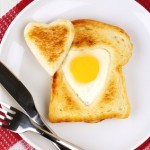 Heart shaped egg in toast for Valentines Day with checked cloth