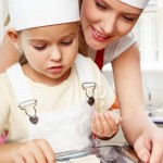 Kitchen. Mother and daughter preparing cream puffs