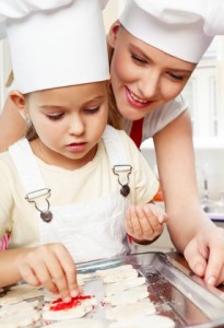 Kitchen. Mother and daughter preparing cream puffs