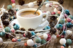Cup of coffee and Christmas garland wreath on the vintage wooden table