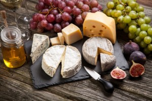 Assortment of cheese with fruits and grapes
