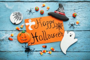 Halloween gingerbread cookies with inscription on orange paper