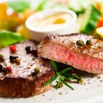 Grilled steak, baked potatoes and vegetables